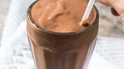Drinking a keto chocolate milkshake with a straw
