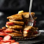A slicked stack of flourless keto pancakes showing their fluffy texture