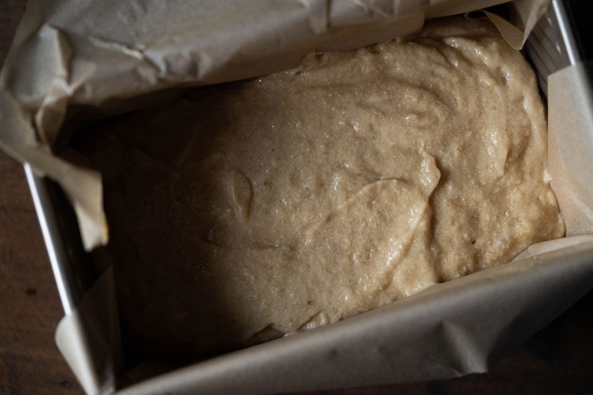 Unbaked banana bread batter fermented with sourdough in a bread pan
